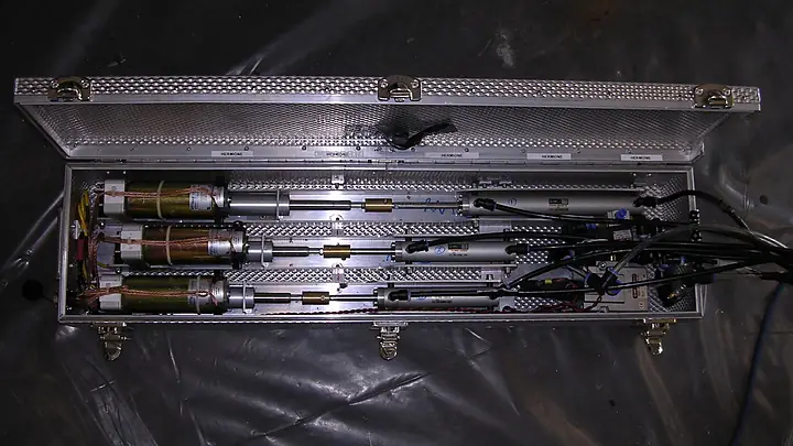 Aluminium case of linear actuators and cables on black plastic