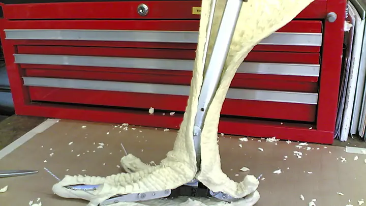 Mechanical eagle claw with foam toes standing on the workshop floor