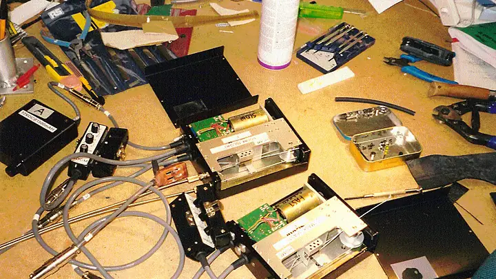 Electronics boxes, cables and tools on a workbench